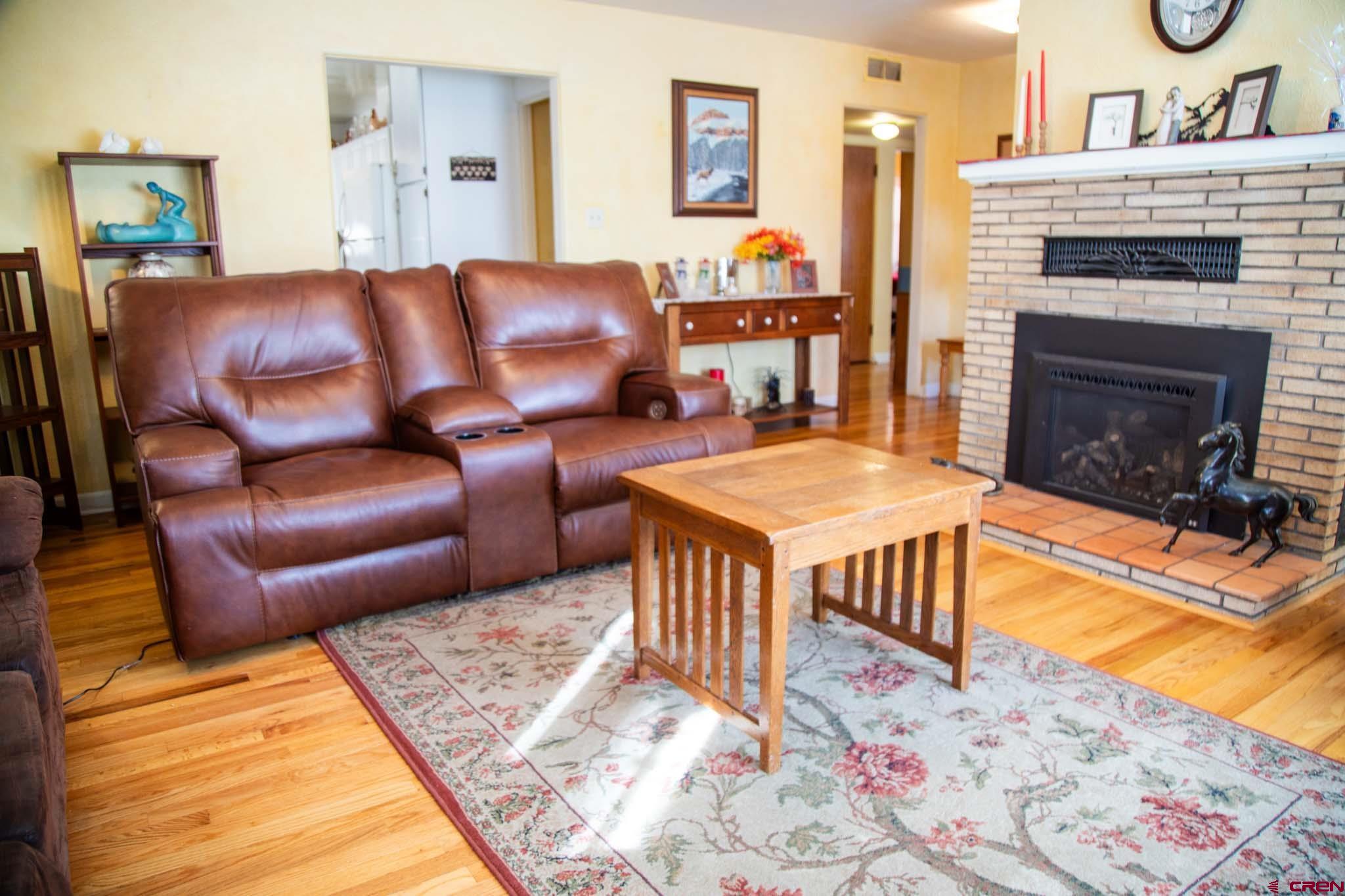 711 First Street Alamosa, CO 81101 - Photo 18 of 21 a living room with furniture and a fireplace