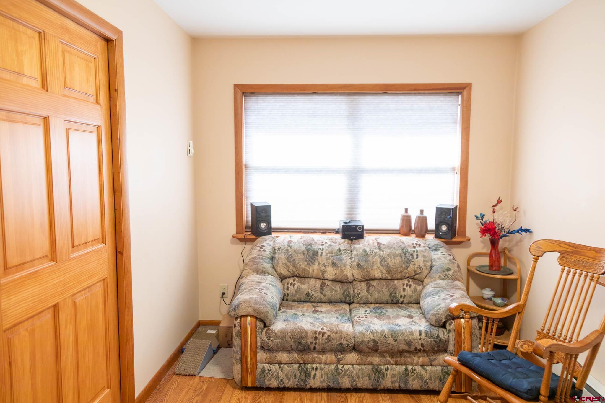 711 First Street Alamosa, CO 81101 - Photo 3 of 21 a living room with furniture and a window