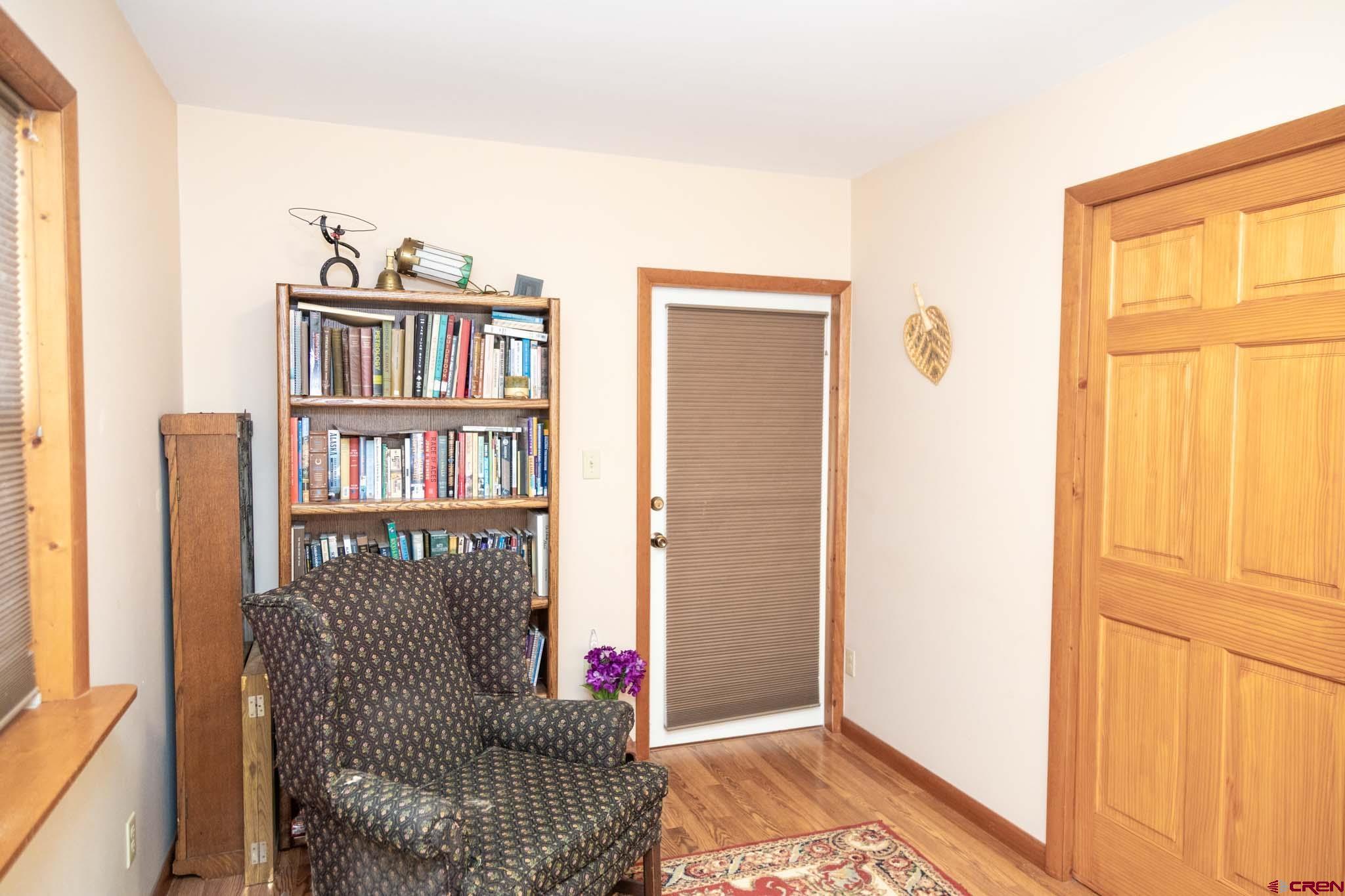 711 First Street Alamosa, CO 81101 - Photo 4 of 21 a living room with furniture and a book shelf