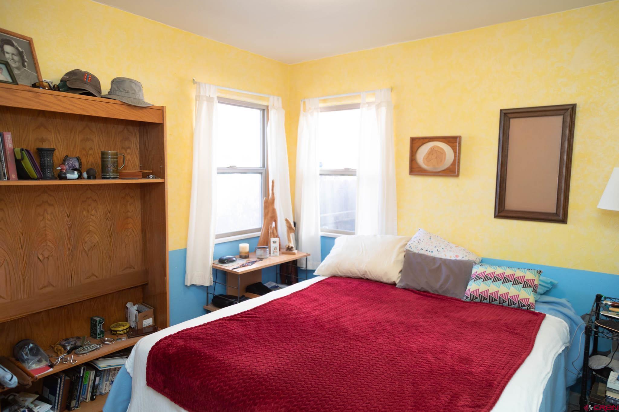 711 First Street Alamosa, CO 81101 - Photo 9 of 21 a bedroom with a bed and a window