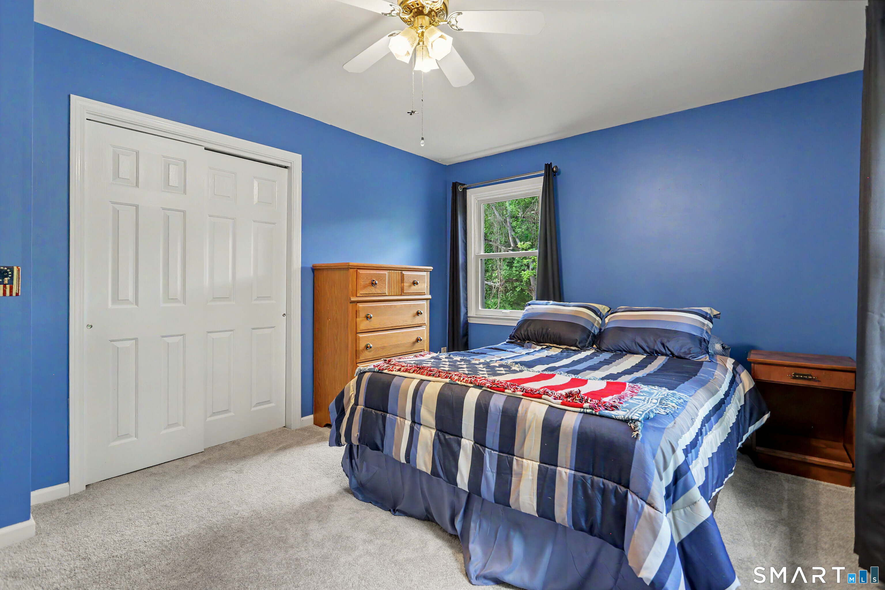 632 Wheelers Farm Road Orange, CT 06477 - Photo 21 of 39 a bedroom with a bed and a chandelier