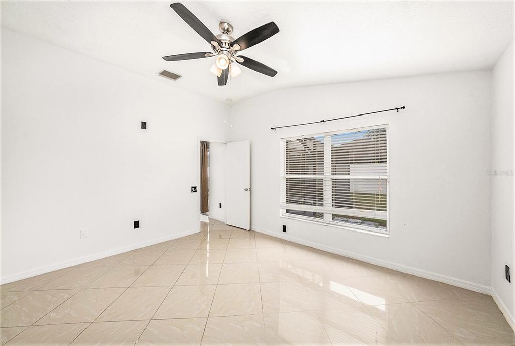 5644 Grindstone Loop Wesley Chapel, FL 33544 - Photo 16 of 29 a view of an empty room with a window