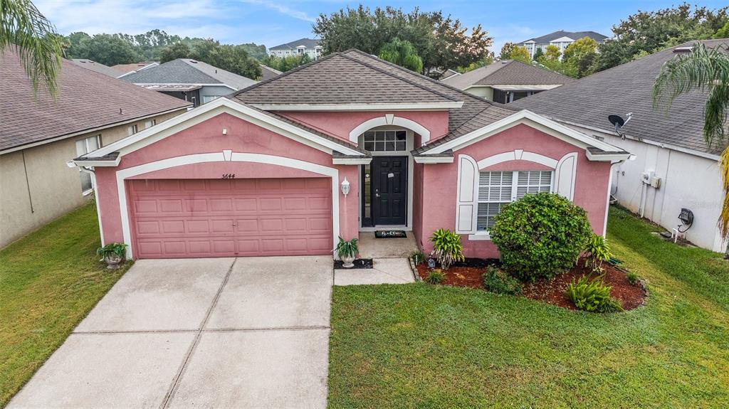 5644 Grindstone Loop Wesley Chapel, FL 33544 - Photo 2 of 29 a front view of a house with a yard