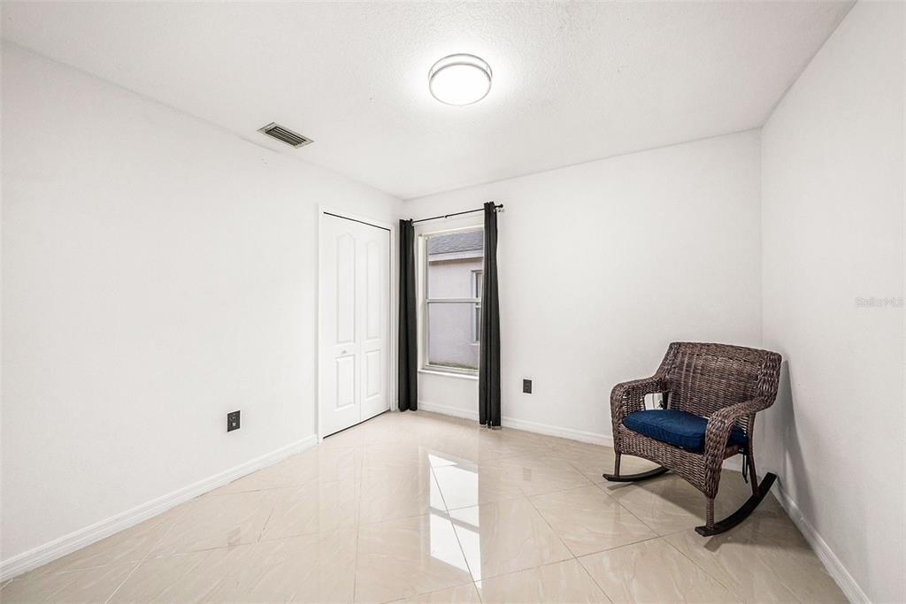 5644 Grindstone Loop Wesley Chapel, FL 33544 - Photo 21 of 29 a living room with furniture and a window