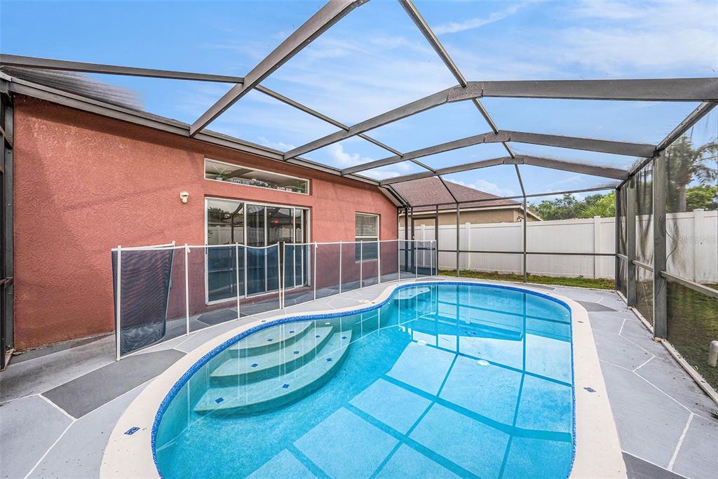 5644 Grindstone Loop Wesley Chapel, FL 33544 - Photo 23 of 29 a view of a swimming pool with a porch