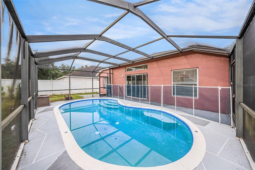 5644 Grindstone Loop Wesley Chapel, FL 33544 - Photo 24 of 29 a view of a swimming pool with a porch