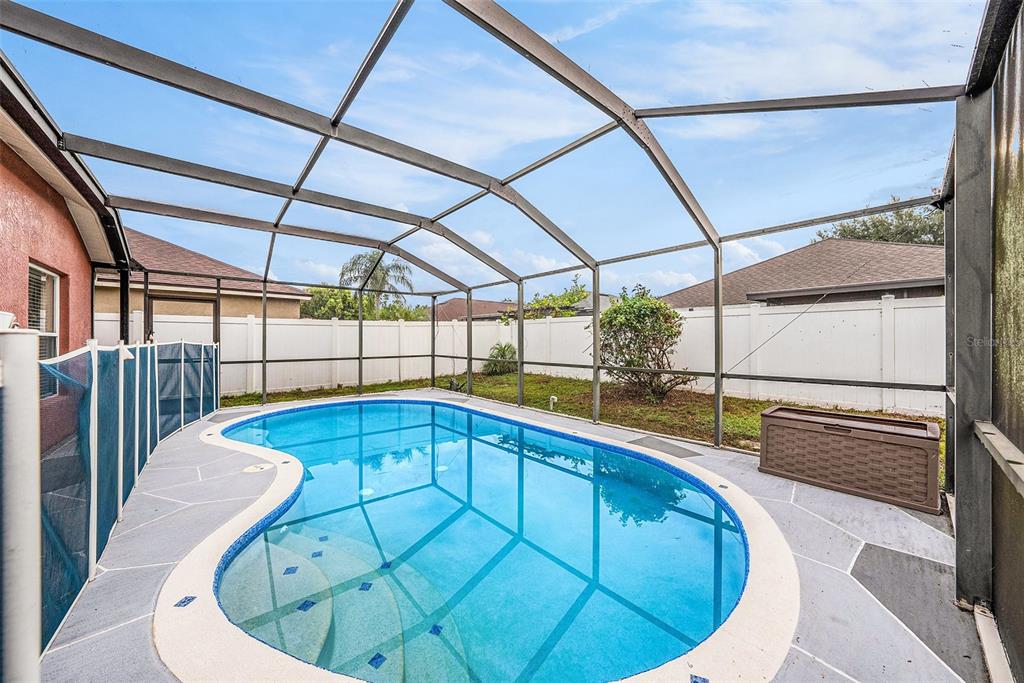 5644 Grindstone Loop Wesley Chapel, FL 33544 - Photo 25 of 29 a view of a swimming pool with a sink and wooden floor