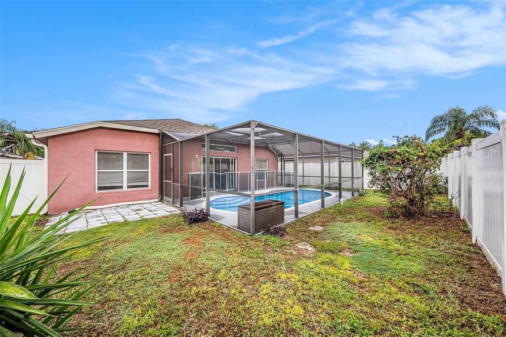 5644 Grindstone Loop Wesley Chapel, FL 33544 - Photo 26 of 29 a view of a house with backyard and sitting area