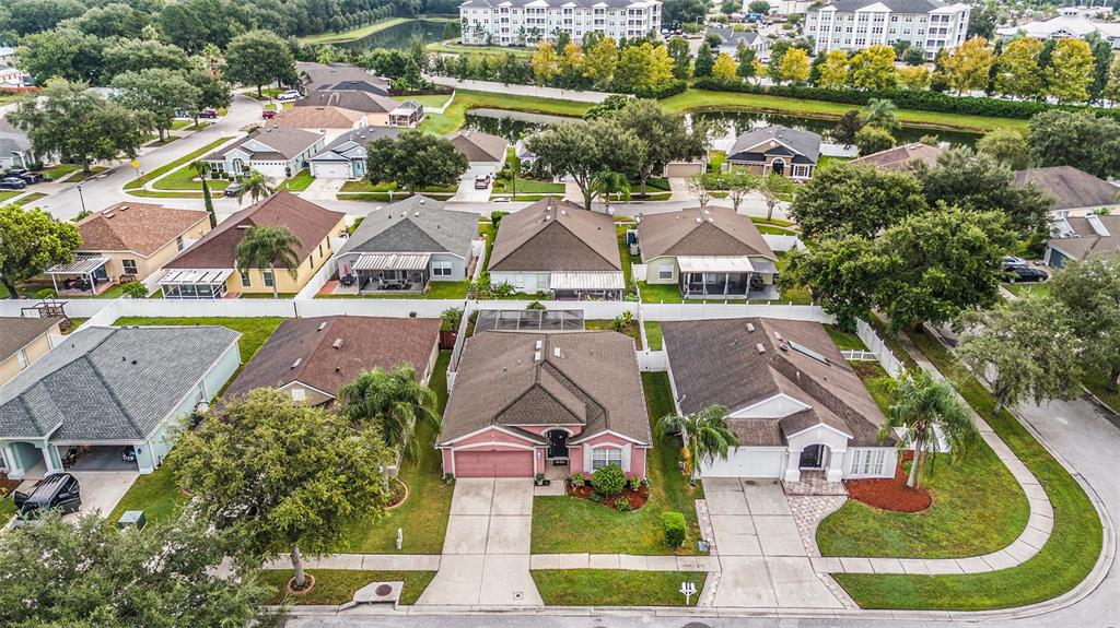5644 Grindstone Loop Wesley Chapel, FL 33544 - Photo 28 of 29 an aerial view of residential houses with outdoor space and swimming pool