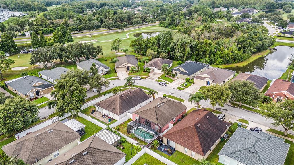 5644 Grindstone Loop Wesley Chapel, FL 33544 - Photo 29 of 29 an aerial view of a house with a swimming pool patio and outdoor seating