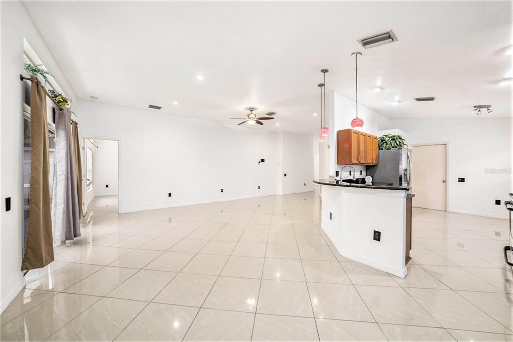 5644 Grindstone Loop Wesley Chapel, FL 33544 - Photo 10 of 29 a view of a kitchen with white cabinets