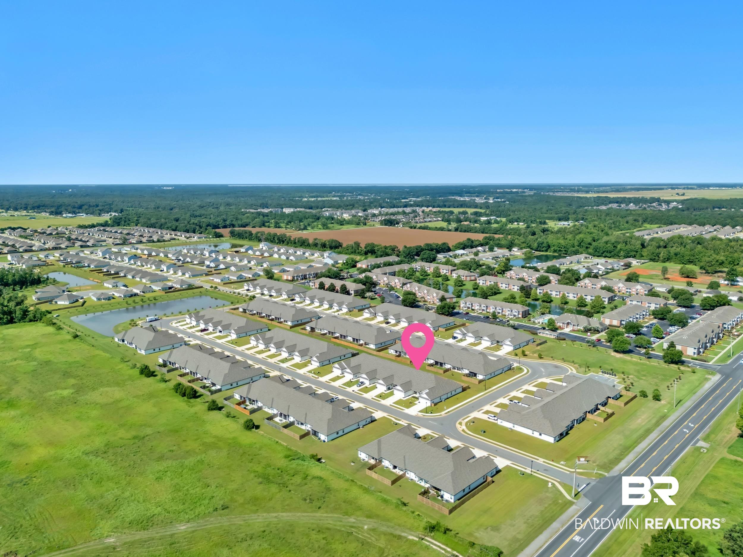 9933 Weller Cove Foley, AL 36535 - Photo 32 of 36 Aerial view of a residential community featuring multiple rows of detached and attached homes
