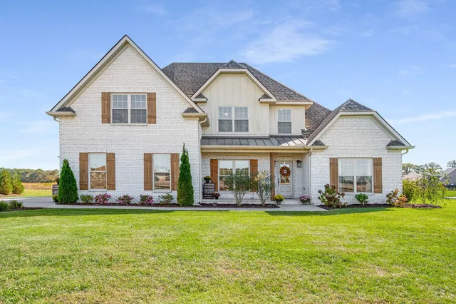 a front view of house with yard and green space