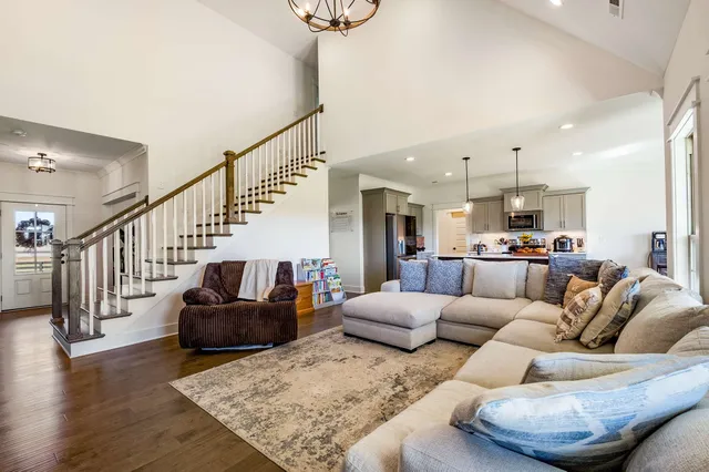 a kitchen with stainless steel appliances a stove a sink a refrigerator a center island and cabinets