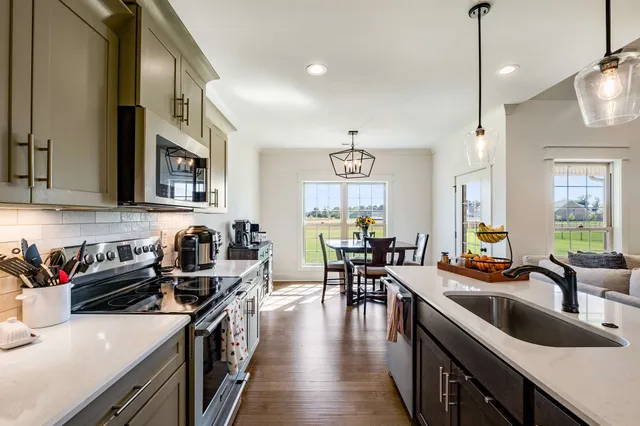 a group of people sitting in a kitchen