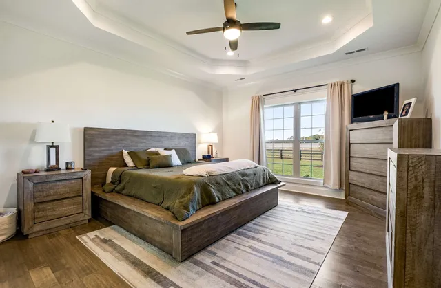 a bedroom with a bed and a television