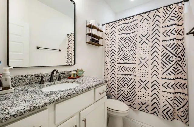 a bedroom with a bed and a lamp