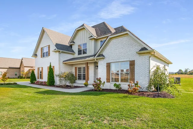 a front view of house with yard and outdoor seating
