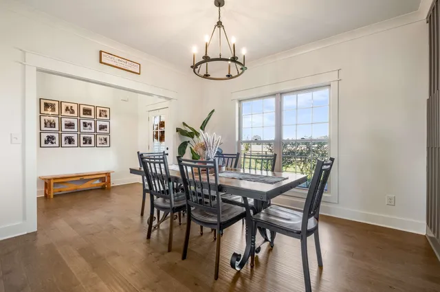 a living room with furniture wooden floor and a flat screen tv