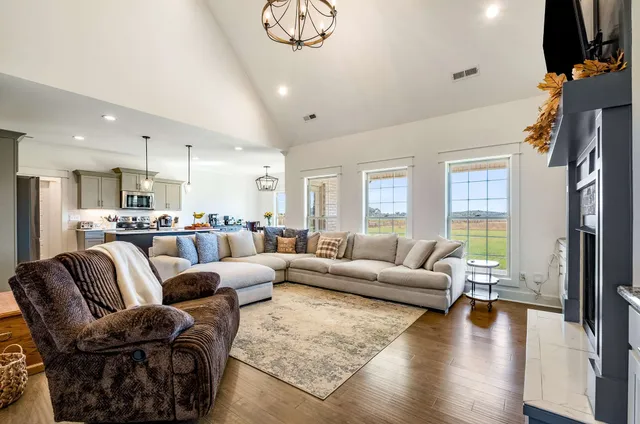 a living room with fireplace furniture and a flat screen tv