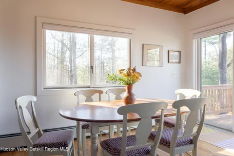 a dining room with furniture and window