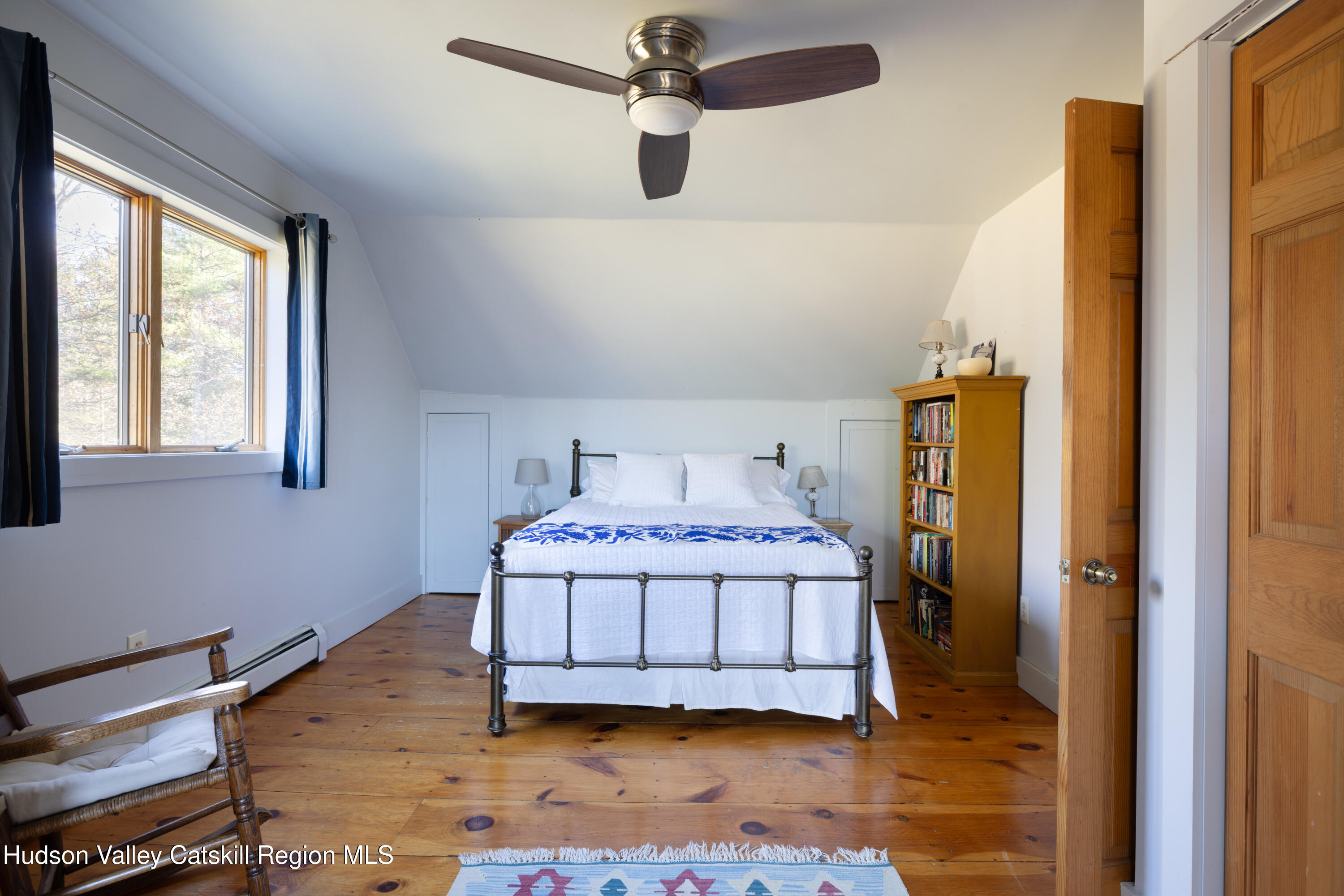 827 Ashokan Road Kingston, NY 12401 - Photo 17 of 36 a bedroom with a bed and wooden floor