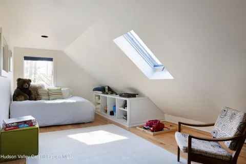 a bedroom with furniture and a window