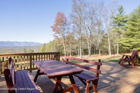 a view of a chairs and table on the deck
