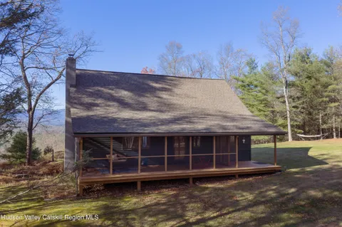 a view of house with a yard