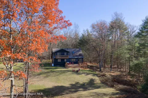 a view of a house with a yard covered in snow