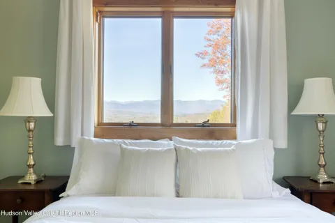 a living room with a large window and a table