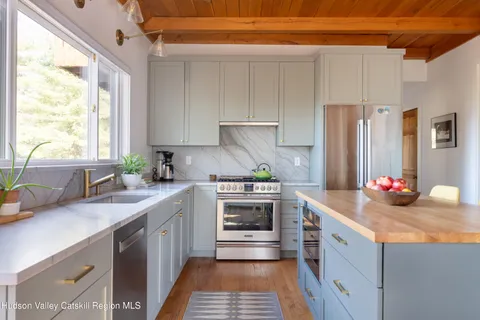 a kitchen with a sink stove and refrigerator
