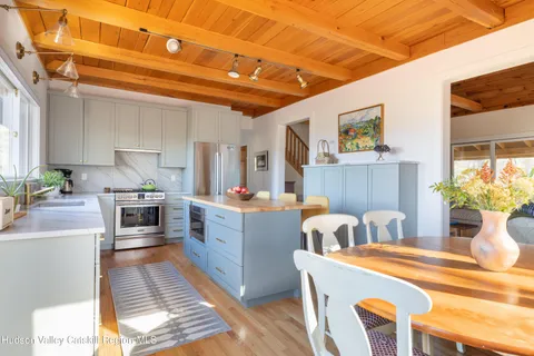 a kitchen with kitchen island a stove a sink and a refrigerator