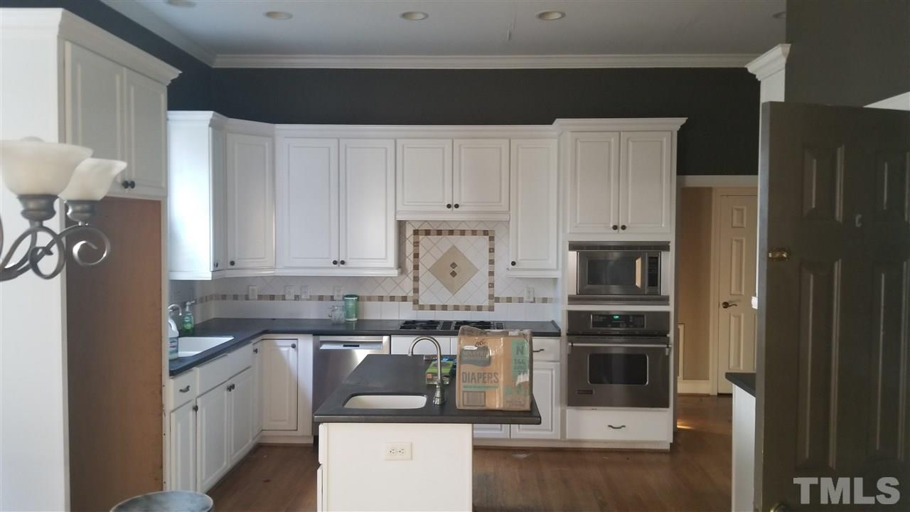 105 Chalon Drive Cary, NC 27511 - Photo 4 of 9 a kitchen with stainless steel appliances granite countertop a stove a sink and a refrigerator