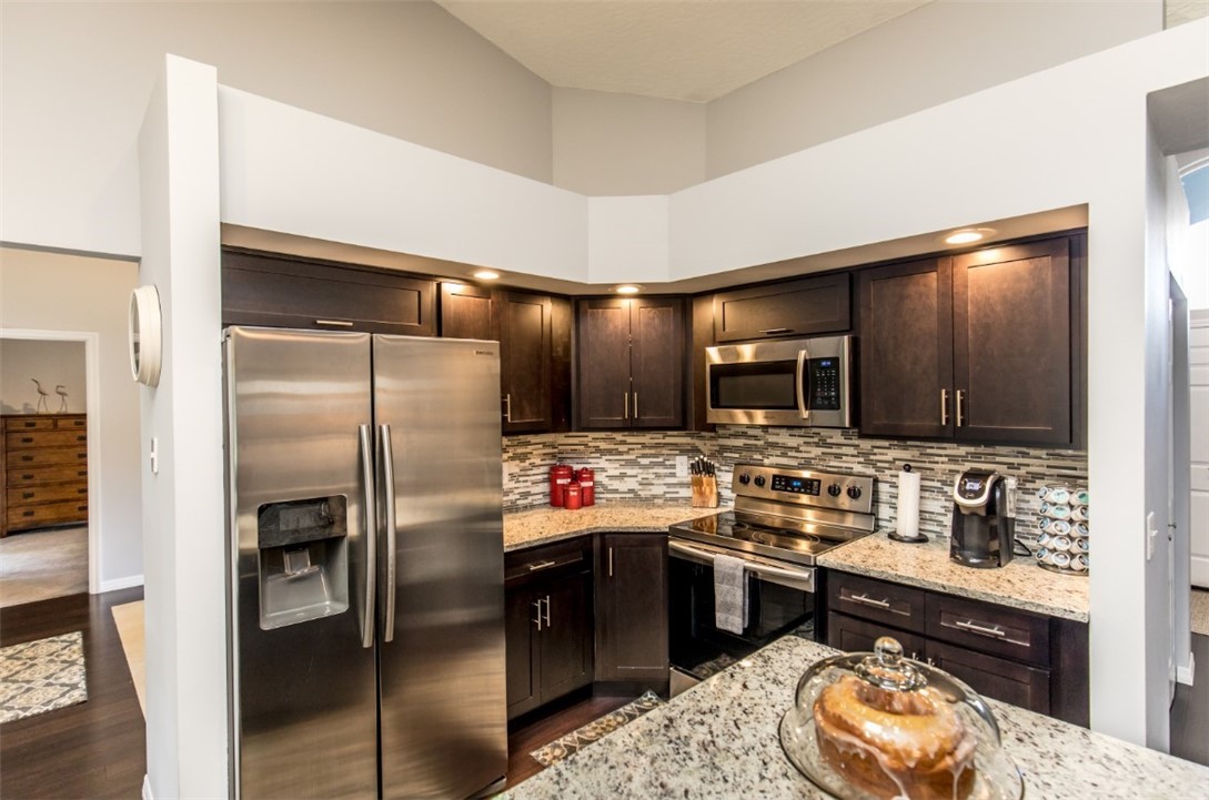 168 Midvale Terrace Sebastian, FL 32958 - Photo 12 of 25 a kitchen with stainless steel appliances granite countertop a refrigerator a stove and a sink