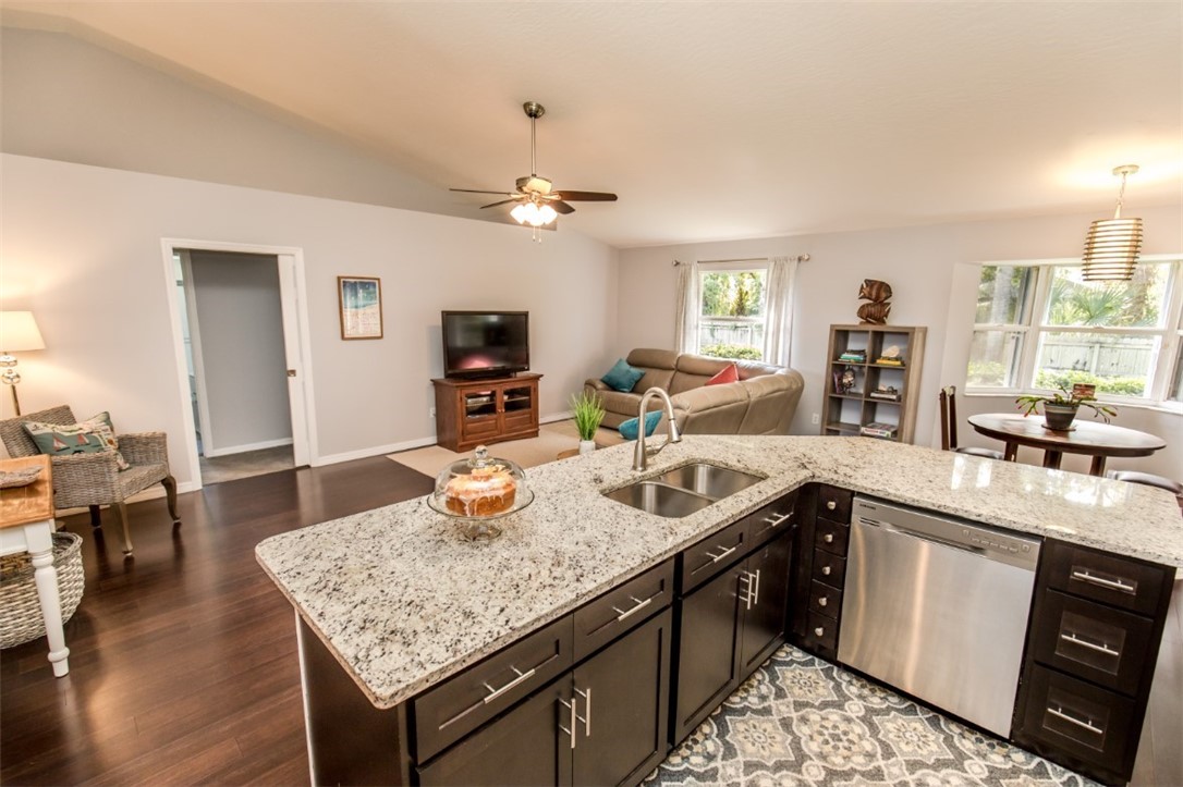 168 Midvale Terrace Sebastian, FL 32958 - Photo 13 of 25 a kitchen with stainless steel appliances granite countertop a sink dishwasher stove and refrigerator with wooden floor