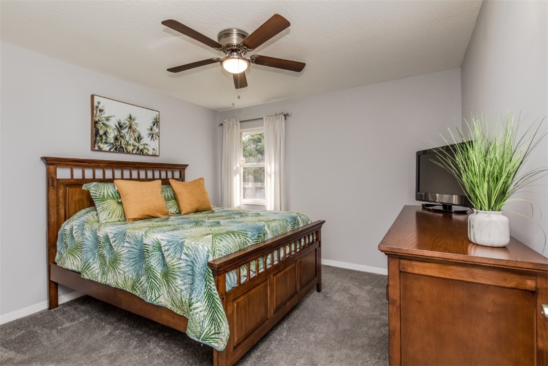 168 Midvale Terrace Sebastian, FL 32958 - Photo 16 of 25 a bedroom with a bed and a chandelier