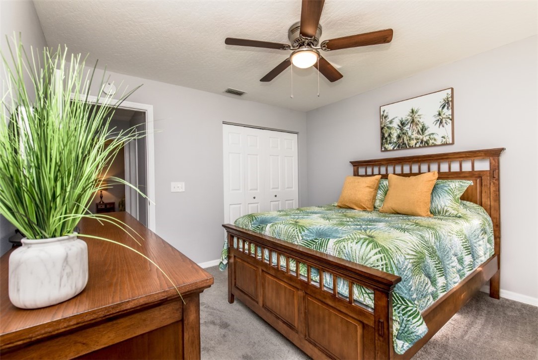 168 Midvale Terrace Sebastian, FL 32958 - Photo 17 of 25 a bed sitting in a bedroom next to a window
