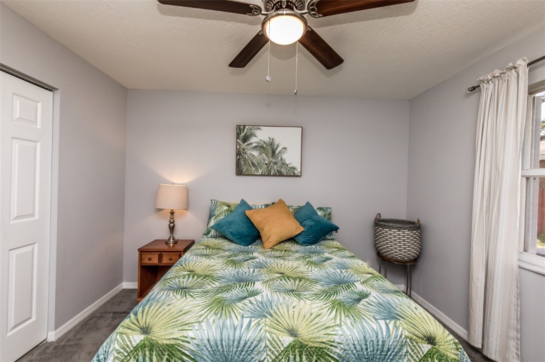 168 Midvale Terrace Sebastian, FL 32958 - Photo 20 of 25 a bedroom with a bed and a chandelier