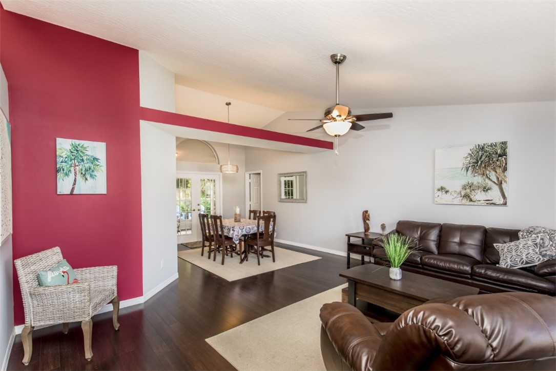 168 Midvale Terrace Sebastian, FL 32958 - Photo 3 of 25 a living room with furniture and a chandelier
