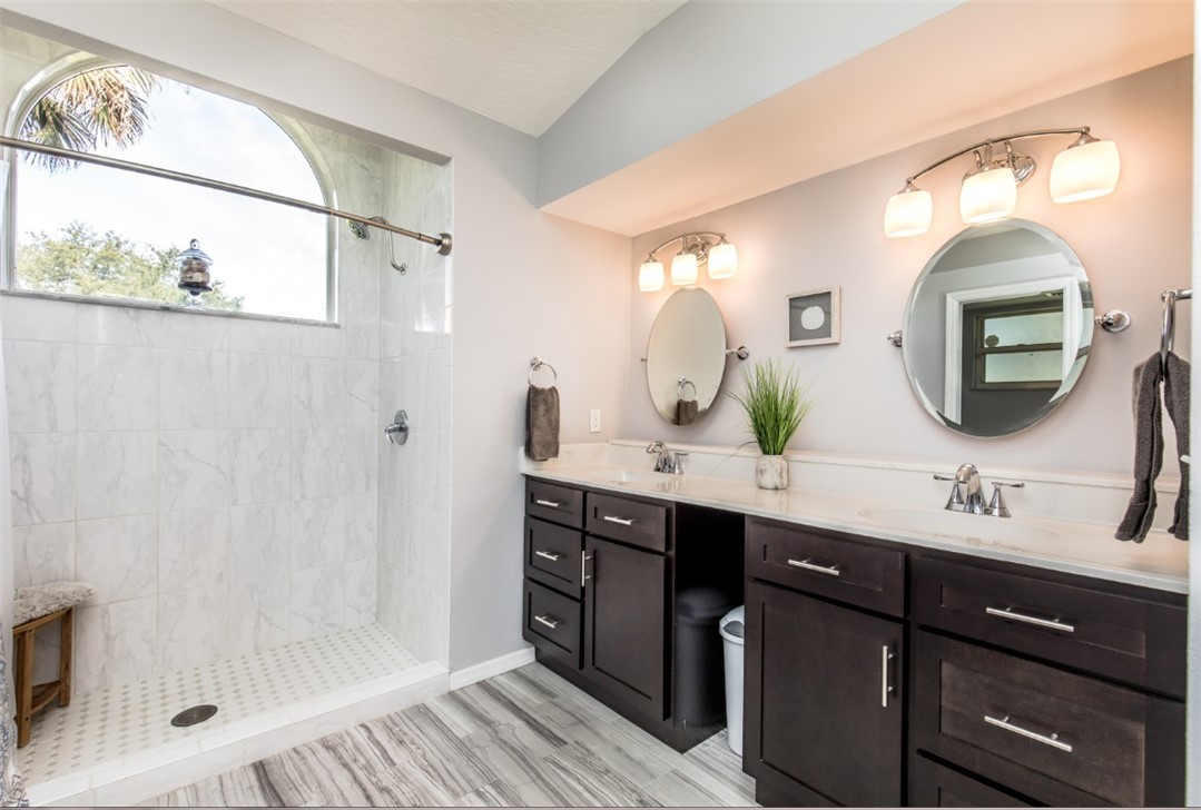 168 Midvale Terrace Sebastian, FL 32958 - Photo 8 of 25 a bathroom with a double vanity sink mirror and shower
