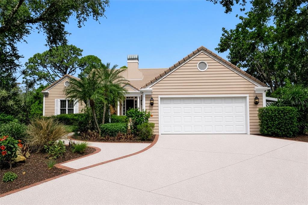 156 Bishopscourt Road Osprey, FL 34229 - Photo 14 of 84 a front view of a house with a yard and a garage