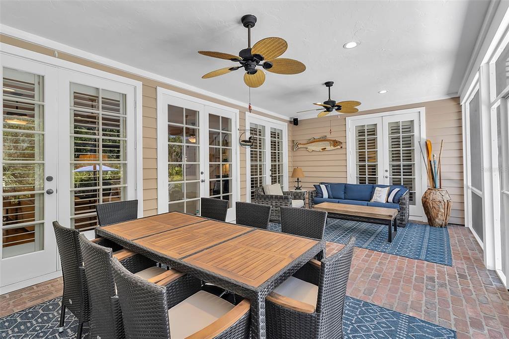 156 Bishopscourt Road Osprey, FL 34229 - Photo 25 of 84 a view of a dining room with furniture and a large window