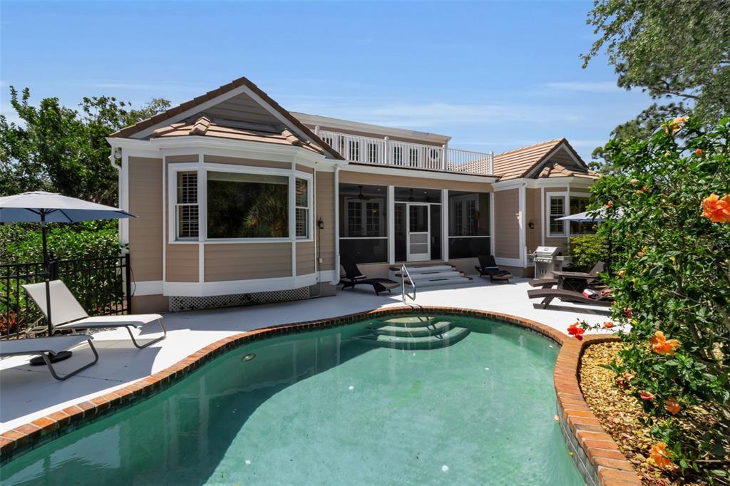 156 Bishopscourt Road Osprey, FL 34229 - Photo 29 of 84 a view of a house with swimming pool and sitting area