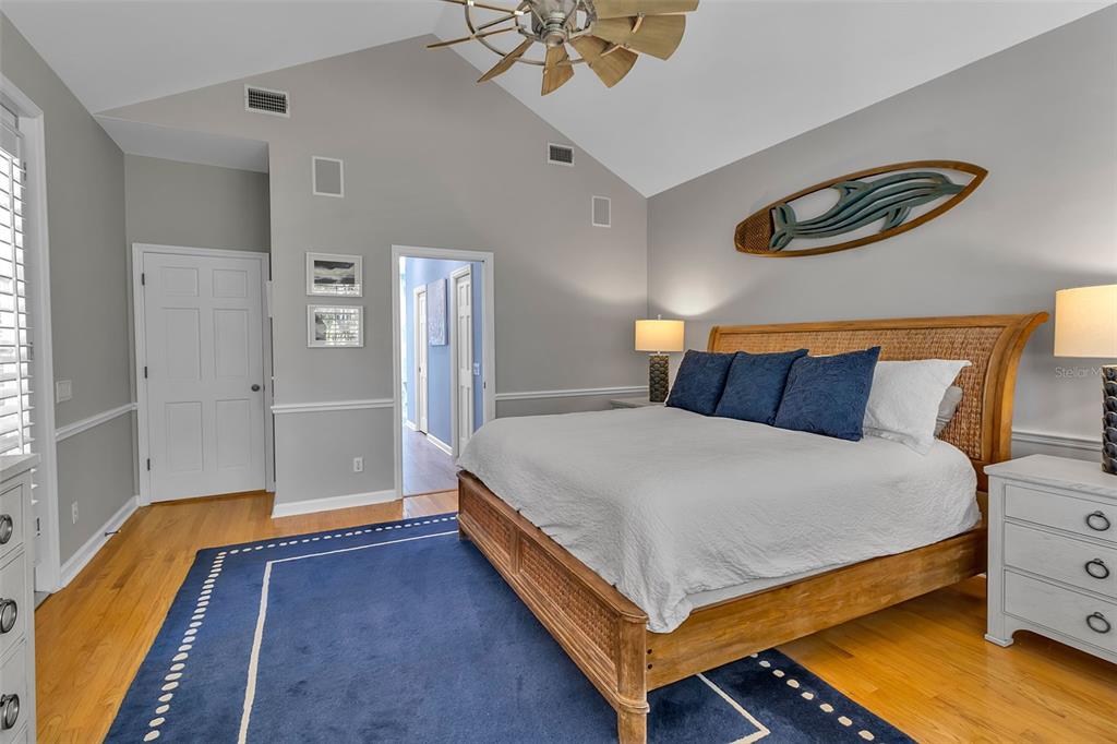 156 Bishopscourt Road Osprey, FL 34229 - Photo 43 of 84 a bedroom with a bed and a chandelier