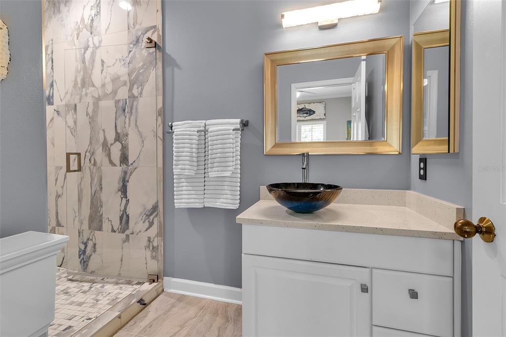 156 Bishopscourt Road Osprey, FL 34229 - Photo 52 of 84 a bathroom with a sink a toilet and a mirror