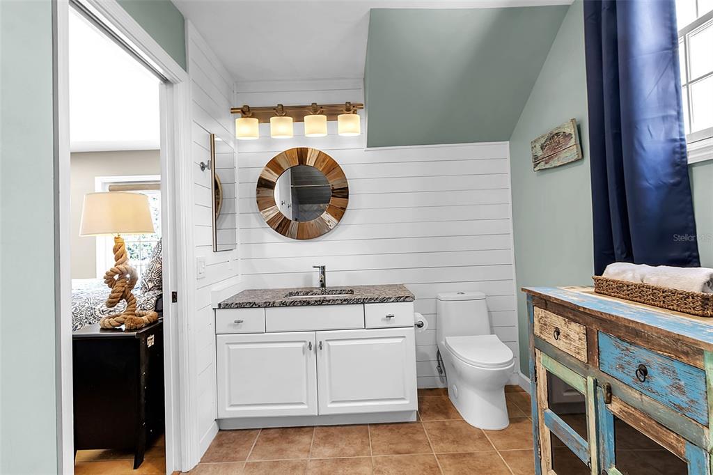 156 Bishopscourt Road Osprey, FL 34229 - Photo 63 of 84 a bathroom with a toilet a sink and mirror