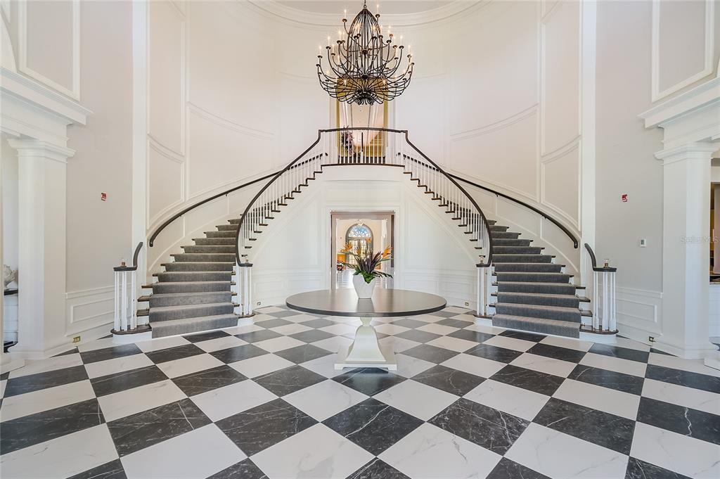 156 Bishopscourt Road Osprey, FL 34229 - Photo 71 of 84 a view of a hallway with a black and white checkered floor