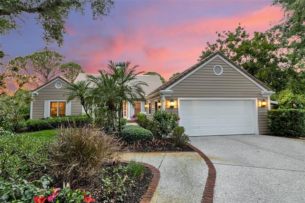 156 Bishopscourt Road Osprey, FL 34229 - Photo 8 of 84 a front view of a house with a yard and garage