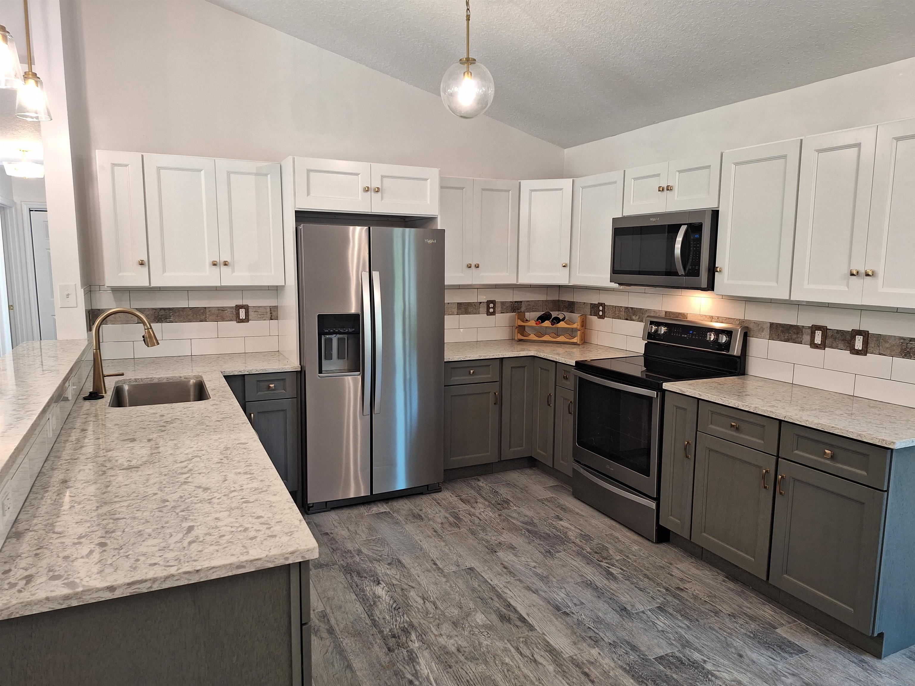 129 15th Street St. Augustine, FL 32080 - Photo 13 of 61 a kitchen with stainless steel appliances granite countertop a stove refrigerator sink and microwave